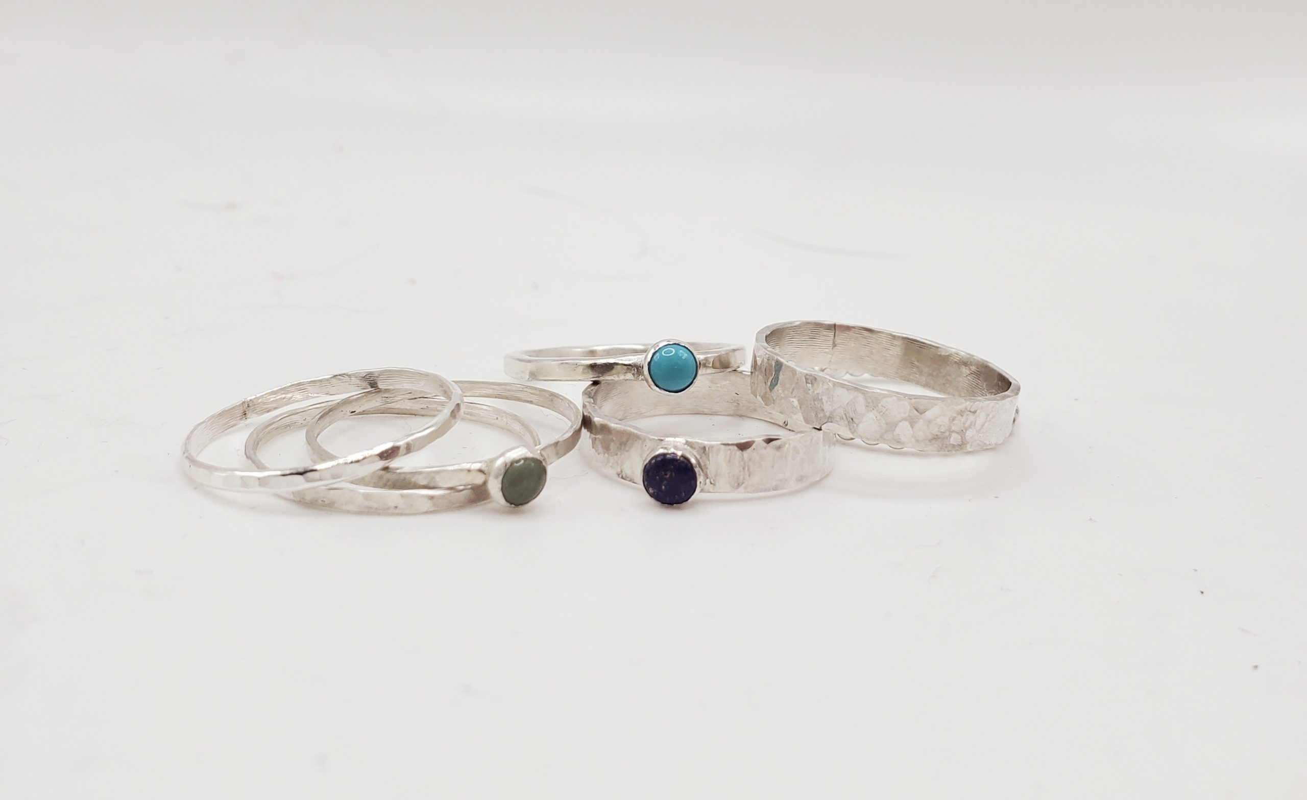 Pile of sterling silver rings. Some with gemstones