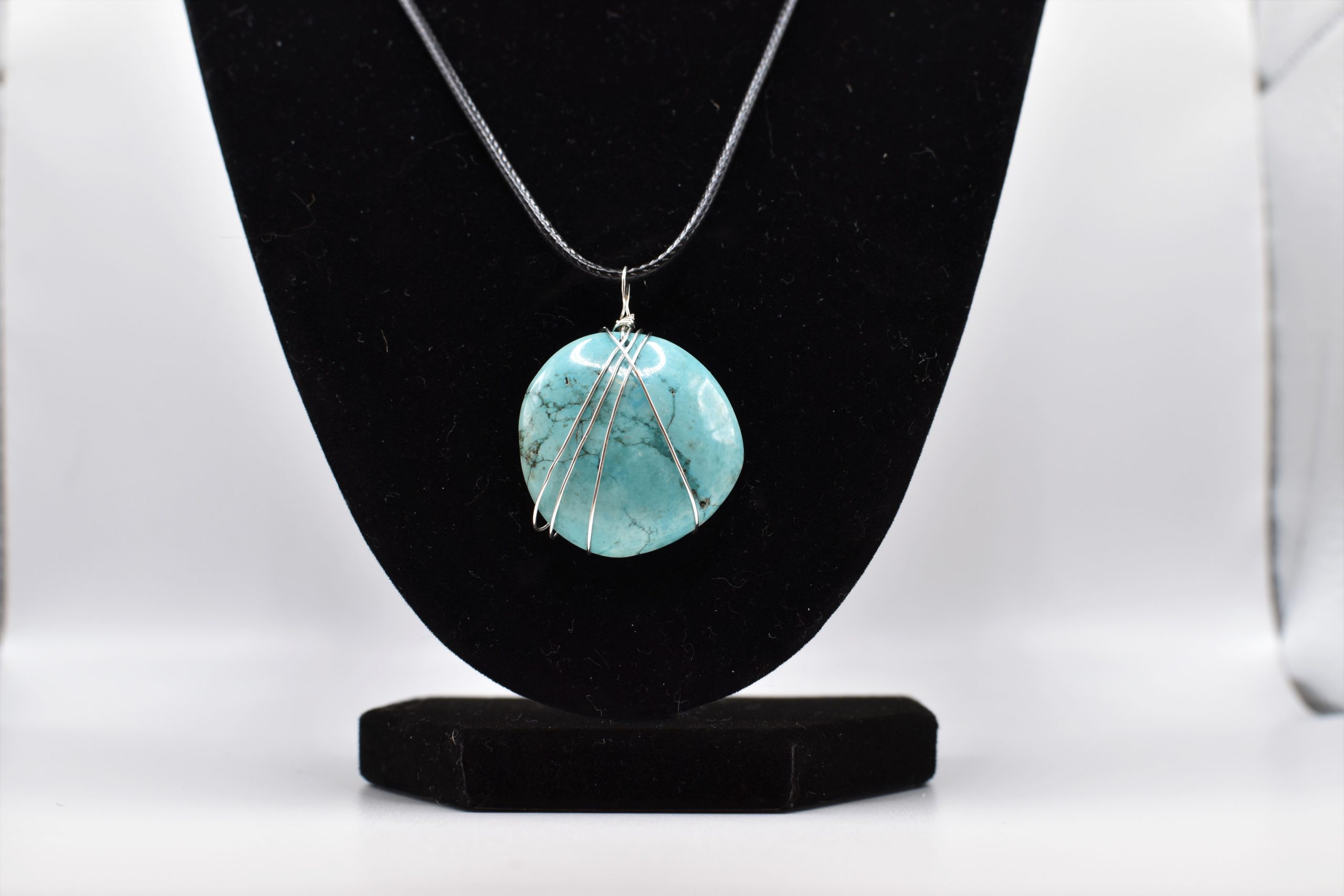 magnesite necklace wrapped simply in sterling silver wire and hung on a black rope necklace