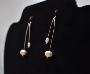 Dangle earrings made of bent sterling silver wire with pearls on the ends